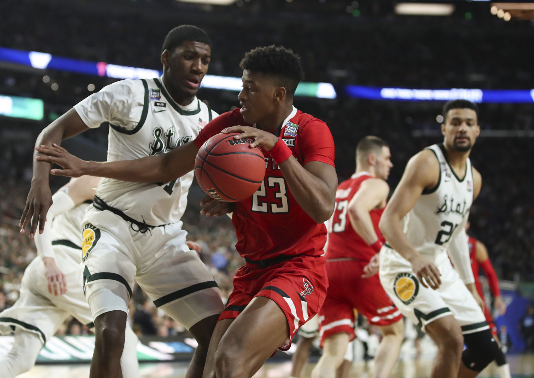 Texas Tech's Jarrett Culver (23) tries to move against Michigan State's Aaron Henry (11) during the second half in a semifinal of the NCAA Tournament Final Four on Saturday, April 6, 2019, at U.S. Bank Stadium in Minneapolis.